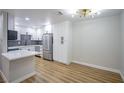 Dining room with modern lighting fixtures, adjoined to kitchen with stainless steel refrigerator at 3151 Soaring Gulls Dr # 1079, Las Vegas, NV 89128