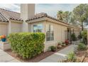 Cozy home featuring lush green bushes, flower pots and a wrought iron garden gate at 3213 Oyster Bay St, Las Vegas, NV 89117