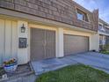 A close-up of the townhome's front entrance, highlighting the unique front door, mailbox, and one car garage at 3251 Southridge Ave, Las Vegas, NV 89121