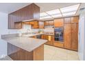A functional kitchen with wood cabinets, laminate countertops, and essential appliances at 3251 Southridge Ave, Las Vegas, NV 89121