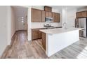 Stylish kitchen boasts a large island, modern appliances, and sleek wood-tone cabinets at 3551 Via Tizzoni St, Henderson, NV 89044