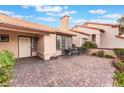 Paver patio with seating and lush greenery, perfect for outdoor relaxation and entertaining at 3901 W Red Coach Ave, North Las Vegas, NV 89031