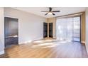 Bright bedroom featuring wood floors, a ceiling fan, and double doors at 5174 S Jones Blvd # 101, Las Vegas, NV 89118