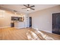 Open concept living room with wood floors flowing into the kitchen area at 5174 S Jones Blvd # 101, Las Vegas, NV 89118