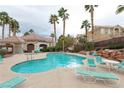 Beautiful community pool area with lounge chairs and surrounding palm trees at 5855 Valley Dr # 2018, North Las Vegas, NV 89031