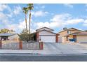 Traditional home boasting a spacious driveway, two-car garage, and brick accents at 608 Cragin Park Dr, Las Vegas, NV 89107