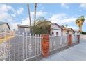 Well-maintained front yard with decorative fencing and mature landscaping at 608 Cragin Park Dr, Las Vegas, NV 89107