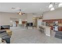 Spacious living room and open kitchen area with a ceiling fan and tile flooring at 6278 Heather Creek Pl, Las Vegas, NV 89122