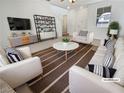 Bright living room with modern furniture and a view to the front of the home at 7211 Hickory Post Ave, Las Vegas, NV 89179
