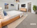 Inviting main bedroom featuring a large bed, neutral carpet, and a ceiling fan at 7211 Hickory Post Ave, Las Vegas, NV 89179