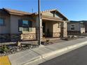 Inviting single-story home featuring a well-manicured front yard with stone accents at 742 Agave Falls St, Henderson, NV 89011