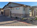 Attractive home exterior with a two-car garage and a brick-paved driveway at 742 Agave Falls St, Henderson, NV 89011