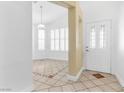Bright foyer with tile flooring and decorative design and modern front door with glass at 8337 Willow Basin Ct, Las Vegas, NV 89131