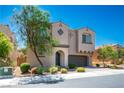 Two-story home featuring desert landscaping and a paver driveway leading to a two-car garage at 9643 Ponderosa Skye Ct, Las Vegas, NV 89166