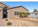 A closer look at the home's front entrance, showcasing the desert landscaping and a secure screen door at 1000 E Enchanted Mesa St, Pahrump, NV 89048