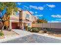 Lovely two-story house with a garage, manicured front yard, and easy driveway access at 11094 Arcadia Sunrise Dr, Henderson, NV 89052