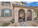 Close-up of the front entrance with an iron gate and desert landscaping at 1111 Frye Mesa Ave, North Las Vegas, NV 89086