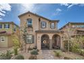 Inviting two-story house with decorative shutters and wrought iron gate entry at 1111 Frye Mesa Ave, North Las Vegas, NV 89086