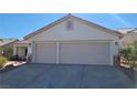 A two-car garage with light beige doors and stone accents at 1147 Light Sky Ave, Henderson, NV 89074