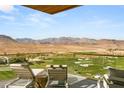 Expansive balcony with comfortable lounge chairs overlooking the desert and golf course at 11660 Summit Club Dr # 204, Las Vegas, NV 89135