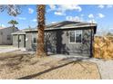 View of a single Gathering home featuring a gray exterior and easy to maintain gravel landscaping at 1417 Joshua Way, Las Vegas, NV 89101