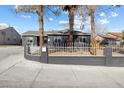 Attractive single-story house with a secure white fence, set back from the sidewalk at 1417 Joshua Way, Las Vegas, NV 89101