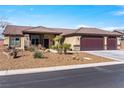 Attractive single-story home with desert landscaping, a three-car garage, and a covered front porch at 150 Spruce Ln, Pahrump, NV 89048