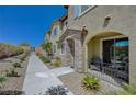 Charming townhome featuring a stone accented entrance and covered porch for relaxing and enjoying the outdoors at 25 Barbara Ln # 67, Las Vegas, NV 89183