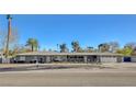 Wide shot of a well maintained, single-story home featuring mature landscaping and a two-car garage at 2711 Ashby Ave, Las Vegas, NV 89102