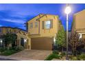 Charming home at twilight featuring a two-car garage, tiled roof, and neatly kept landscaping at 3026 Coveri Ct, Las Vegas, NV 89141