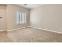 Neutral bedroom with carpet flooring, white trim, and shuttered window at 3516 Bryan Keith Ave, North Las Vegas, NV 89031