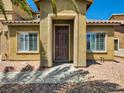 Front entrance featuring a covered porch with decorative stone and desert landscaping at 3516 Bryan Keith Ave, North Las Vegas, NV 89031