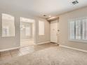 Open-concept living room and dining area featuring neutral paint and carpet at 3516 Bryan Keith Ave, North Las Vegas, NV 89031