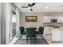 Stylish dining area featuring a modern table, sleek chairs, contemporary lighting, and patio access at 356 Free Fall Ave, North Las Vegas, NV 89084