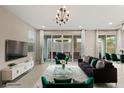 Bright living room with tile floors, sliding glass doors, modern furniture, and elegant decor at 356 Free Fall Ave, North Las Vegas, NV 89084