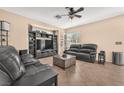 Comfortable living room with a ceiling fan, tile flooring, and neutral colors at 3645 Bella Legato Ave, North Las Vegas, NV 89081