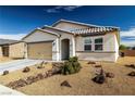 View of front exterior, showcasing desert landscaping, beige facade, and a covered entryway at 3862 E Summit Ave, Pahrump, NV 89061