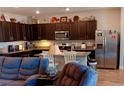 Modern kitchen featuring stainless steel appliances, dark cabinetry, granite countertops, and a breakfast bar at 3862 E Summit Ave, Pahrump, NV 89061