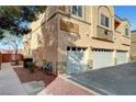 Exterior angle of peach-stucco home, showcasing its well-maintained landscaping at 4020 Smokey Fog Ave # 201, North Las Vegas, NV 89081