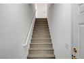 Carpeted staircase with white railing leading to the upper level at 4020 Smokey Fog Ave # 201, North Las Vegas, NV 89081