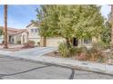 Attractive home with a large tree in the front yard and a two-car garage at 4446 Scarlet Sea Ave, North Las Vegas, NV 89031