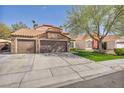 Charming single-story home with a three car garage and a well-manicured lawn at 4516 Whelk Pl, North Las Vegas, NV 89031