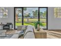 Comfortable living room with a neutral sofa and a view of the landscaped backyard through sliding glass doors at 5209 Rim View Ln, Las Vegas, NV 89130