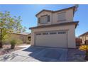 Two-story home featuring desert landscaping, neutral stucco, and a two-car garage, creating curb appeal at 53 Hoke Edward Ct, North Las Vegas, NV 89031