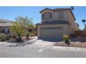 Two-story home featuring desert landscaping, neutral stucco, and a two-car garage, creating curb appeal at 53 Hoke Edward Ct, North Las Vegas, NV 89031