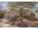 Well-maintained single-story house with a two-car garage and low-maintenance desert landscaping at 5989 Sierra Medina Ave, Las Vegas, NV 89139