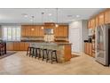 A spacious kitchen features an island with seating, stainless steel appliances, and ample cabinetry at 6156 Twilight Cove Cir, Las Vegas, NV 89131