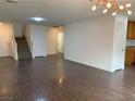 Open-concept living room featuring stairs and hardwood floors at 6425 W Haleh Ave, Las Vegas, NV 89141