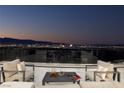 Balcony seating with furniture, set against a stunning panoramic cityscape at twilight at 667 Solitude Rock Ct, Henderson, NV 89012