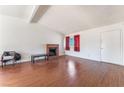 Cozy living room features a brick fireplace and wood flooring at 6731 Fallona Ave, Las Vegas, NV 89156